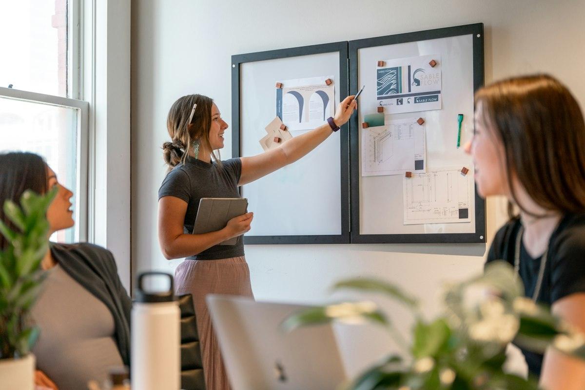 A team reviewing plans pinned to a board